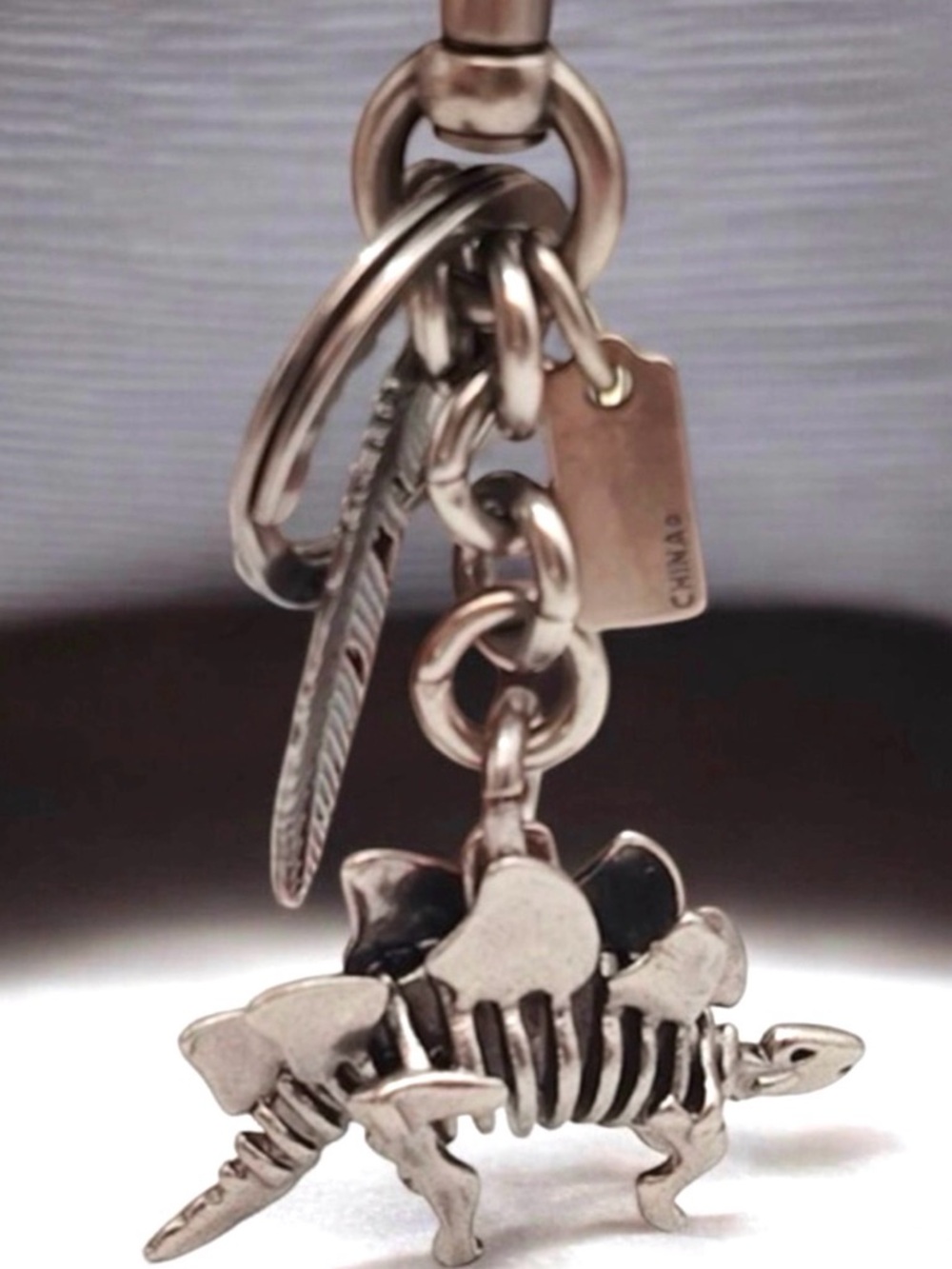 COACH STEGGY STEGOSAURUS & FEATHER NICKEL BAG CHARM KEYRING 65134